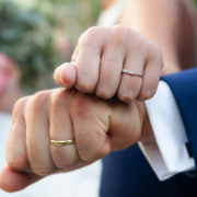 a newlywed couple showing their wedding bands - Estate Planning for Newlyweds